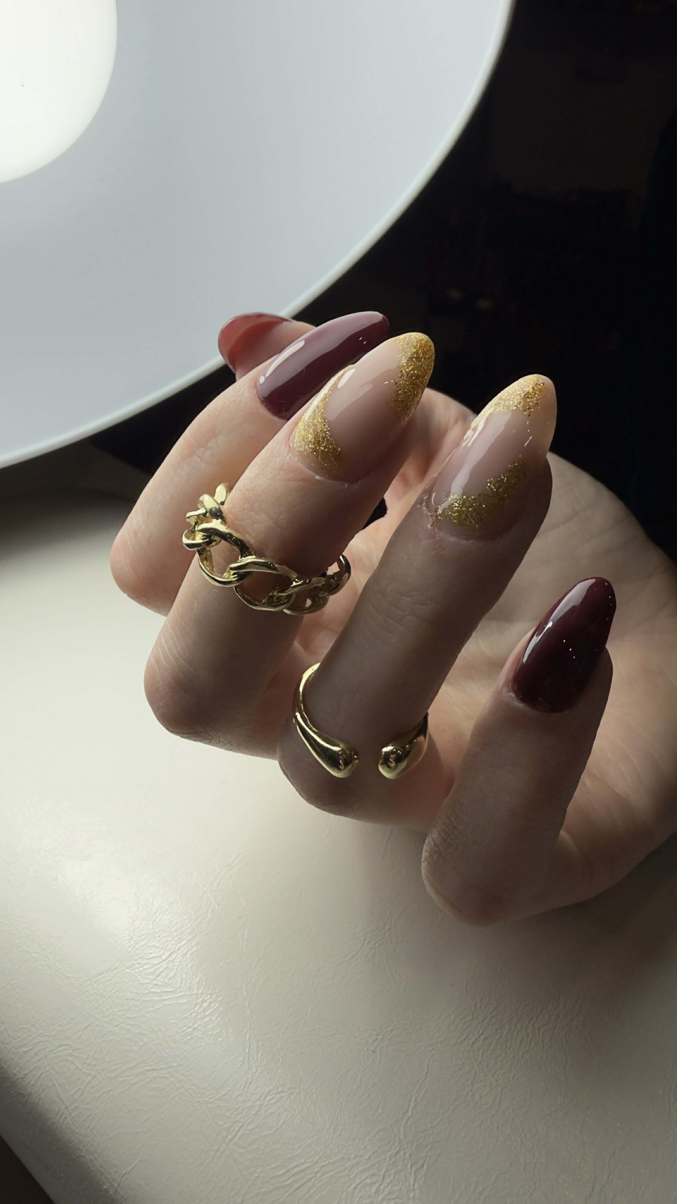 Burgundy and gold glitter nails